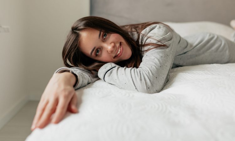 admirable-european-woman-pajamas-lying-white-bed-resting-good-day-home