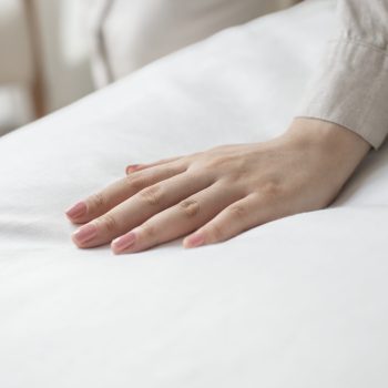 Hand on a soft duvet