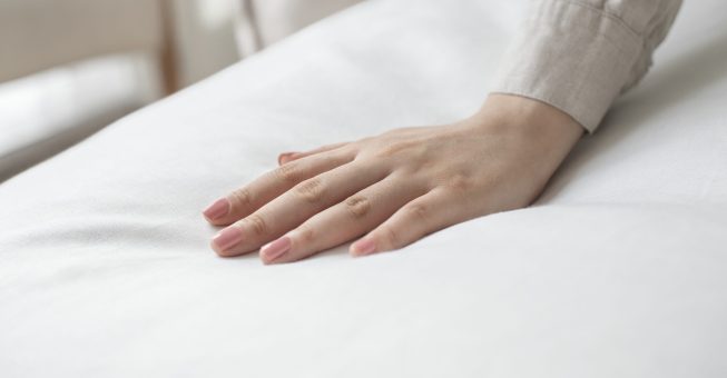 Hand on a soft duvet