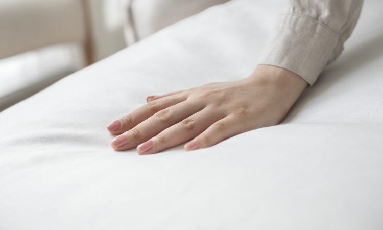 Hand on a soft duvet