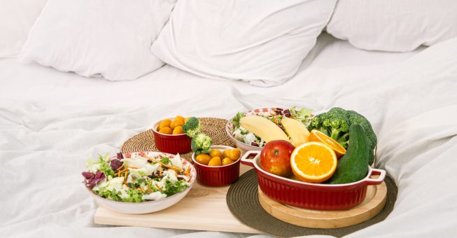 Healthy healthy Breakfast with fruit on a tray in bed. The concept of healthy eating .