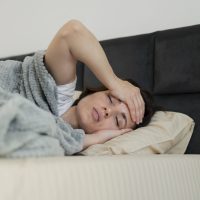 medium-shot-ill-woman-laying-bed