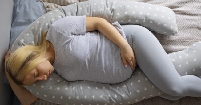 top-view-pregnant-woman-using-nursing-pillow