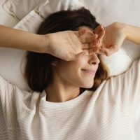 top-view-woman-bed-waking-up-home