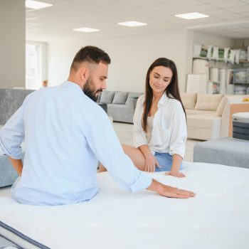 Woman with her husband at the furniture store showroom.