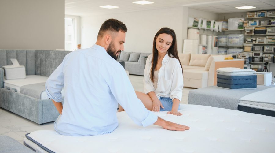 Woman with her husband at the furniture store showroom.